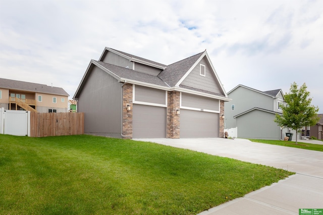 6311 N 169th St, Omaha, NE 68116 - view of front facade with stone siding, concrete driveway, roof with shingles, and an attached garage