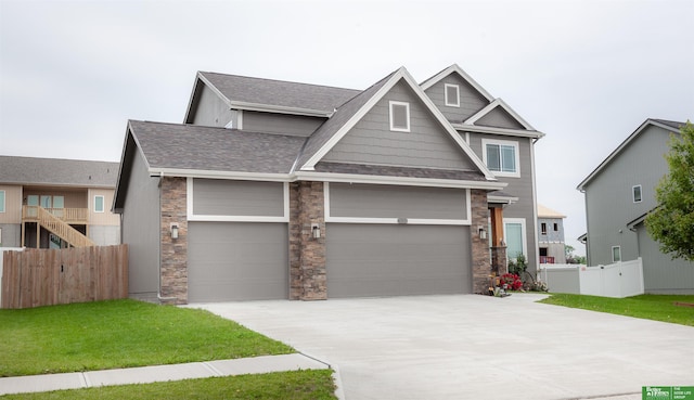 6311 N 169th St, Omaha, NE 68116 - craftsman inspired home featuring stone siding, driveway, roof with shingles, and a garage