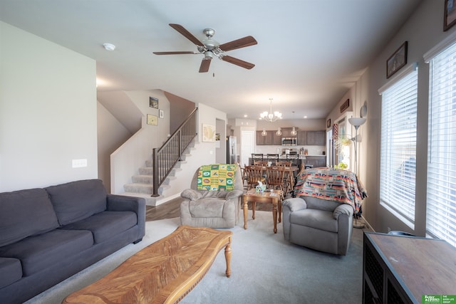 6311 N 169th St, Omaha, NE 68116 - carpeted living room with stairway, a ceiling fan, plenty of natural light, and a chandelier