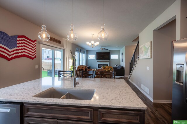 6311 N 169th St, Omaha, NE 68116 - kitchen featuring a sink, open floor plan, dark wood-type flooring, stainless steel appliances, and a chandelier
