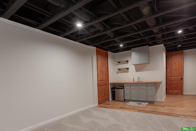 6311 N 169th St, Omaha, NE 68116 - finished below grade area with bar with sink, baseboards, and light colored carpet