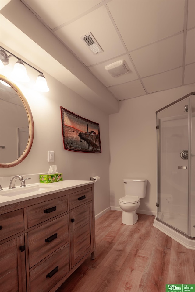 6311 N 169th St, Omaha, NE 68116 - bathroom with vanity, wood finished floors, a shower stall, baseboards, and toilet