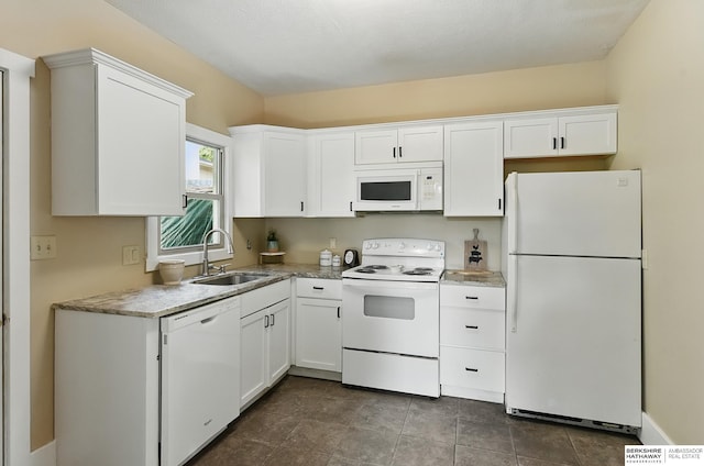 2319 B St, Omaha, NE 68108 - kitchen with white appliances, a sink, and white cabinets