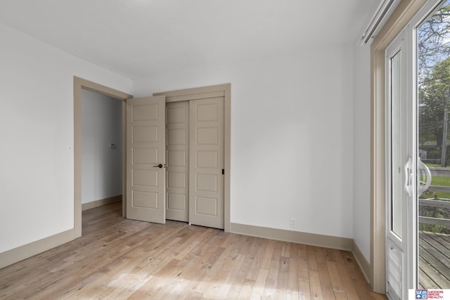 1141 S 48th St, Lincoln, NE 68510 - unfurnished bedroom featuring light wood-style flooring, baseboards, and a closet