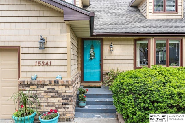 15341 Davenport Cir, Omaha, NE 68154 - property entrance featuring a shingled roof and stone siding