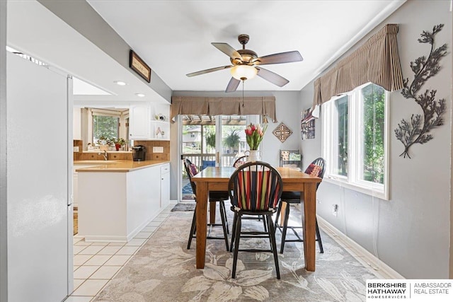 15341 Davenport Cir, Omaha, NE 68154 - dining space featuring ceiling fan, light tile patterned floors, and baseboards