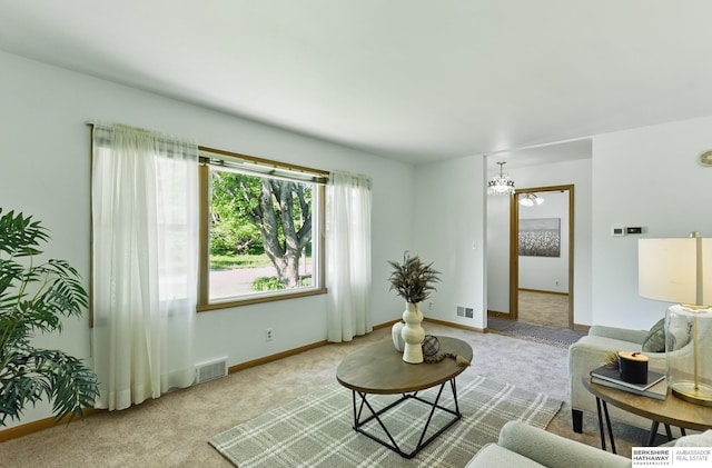 4314 Oak St, Omaha, NE 68105 - living room with carpet floors, a chandelier, and baseboards
