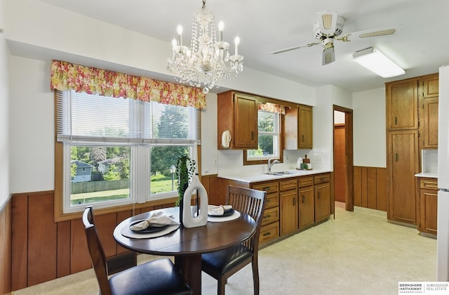 4314 Oak St, Omaha, NE 68105 - dining area with a wainscoted wall, ceiling fan, a chandelier, and wood walls