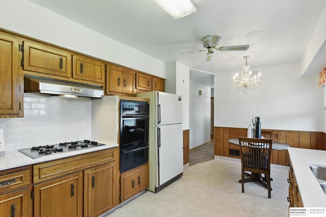 4314 Oak St, Omaha, NE 68105 - kitchen featuring a warming drawer, freestanding refrigerator, under cabinet range hood, black oven, and light colored carpet