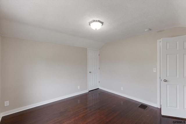 3013 Decatur St, Omaha, NE 68111 - unfurnished room with lofted ceiling, dark wood finished floors, baseboards, a textured ceiling, and a smoke detector