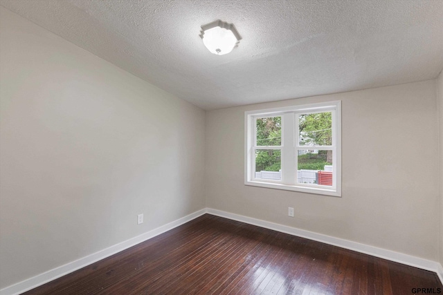 3013 Decatur St, Omaha, NE 68111 - unfurnished room with baseboards, dark wood finished floors, and a textured ceiling