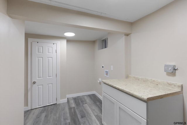 3013 Decatur St, Omaha, NE 68111 - laundry room with light wood-type flooring, hookup for an electric dryer, hookup for a washing machine, baseboards, and cabinet space