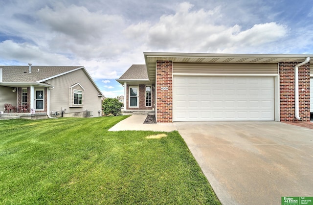 6200 Maple View Dr, Lincoln, NE 68512 - view of front of house with brick siding, driveway, a front yard, and a garage