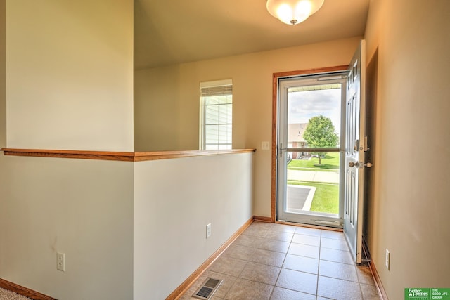 6200 Maple View Dr, Lincoln, NE 68512 - doorway to outside with baseboards and light tile patterned floors