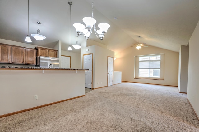 6200 Maple View Dr, Lincoln, NE 68512 - kitchen featuring freestanding refrigerator, lofted ceiling, light colored carpet, ceiling fan, and hanging light fixtures