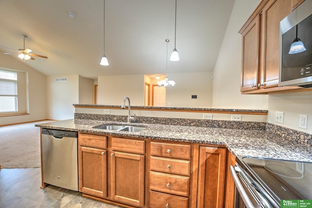 6200 Maple View Dr, Lincoln, NE 68512 - kitchen featuring appliances with stainless steel finishes, a sink, vaulted ceiling, dark stone counters, and a ceiling fan