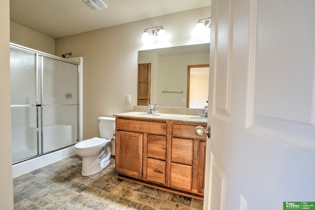 6200 Maple View Dr, Lincoln, NE 68512 - bathroom featuring a stall shower, toilet, and double vanity