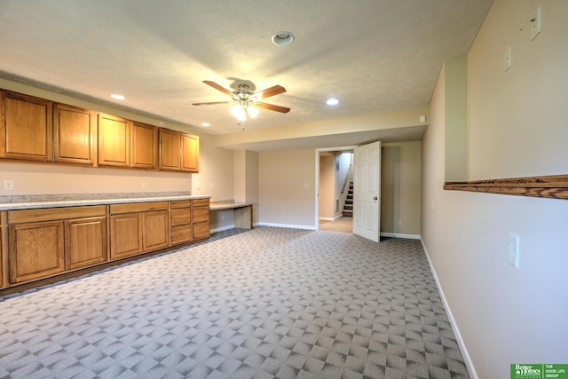 6200 Maple View Dr, Lincoln, NE 68512 - kitchen with brown cabinets, recessed lighting, ceiling fan, light countertops, and baseboards