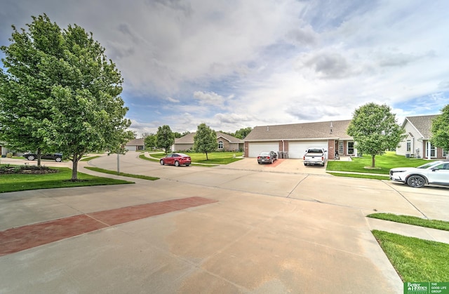 6200 Maple View Dr, Lincoln, NE 68512 - view of concrete driveway with a residential view and sidewalks