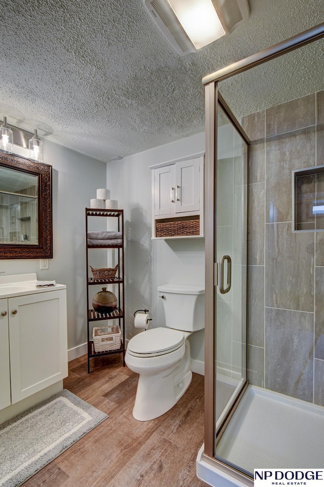 4705 N 95th St, Omaha, NE 68134 - full bath featuring toilet, wood finished floors, vanity, a stall shower, and baseboards