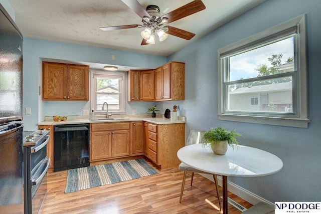 4705 N 95th St, Omaha, NE 68134 - kitchen featuring black appliances, a sink, light wood-style flooring, light countertops, and a ceiling fan