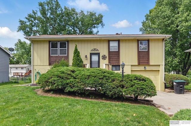 128 S 110th St, Omaha, NE 68154 - split foyer home featuring an attached garage, driveway, and a front lawn