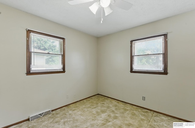128 S 110th St, Omaha, NE 68154 - unfurnished room featuring light colored carpet, baseboards, and a ceiling fan