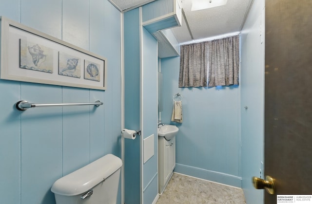 128 S 110th St, Omaha, NE 68154 - bathroom featuring vanity, toilet, and baseboards