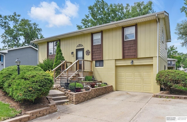128 S 110th St, Omaha, NE 68154 - view of front facade with an attached garage and driveway