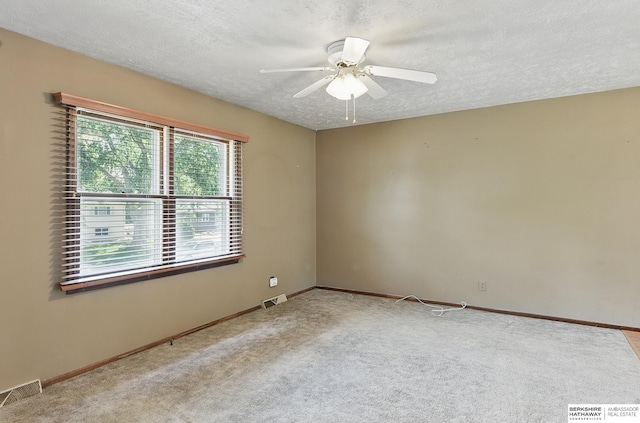 128 S 110th St, Omaha, NE 68154 - unfurnished room featuring ceiling fan, a textured ceiling, carpet floors, and baseboards