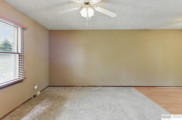 128 S 110th St, Omaha, NE 68154 - empty room featuring a textured ceiling, ceiling fan, and baseboards
