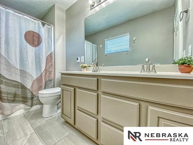 14603 Nebraska Cir, Omaha, NE 68116 - full bath with double vanity, toilet, and marble finish flooring