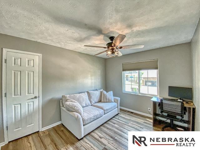 14603 Nebraska Cir, Omaha, NE 68116 - office space with a textured ceiling, wood finished floors, ceiling fan, and baseboards