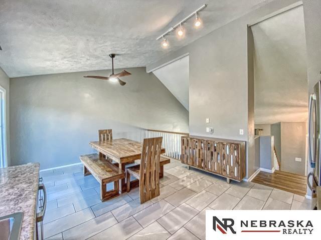 14603 Nebraska Cir, Omaha, NE 68116 - dining room featuring ceiling fan and vaulted ceiling