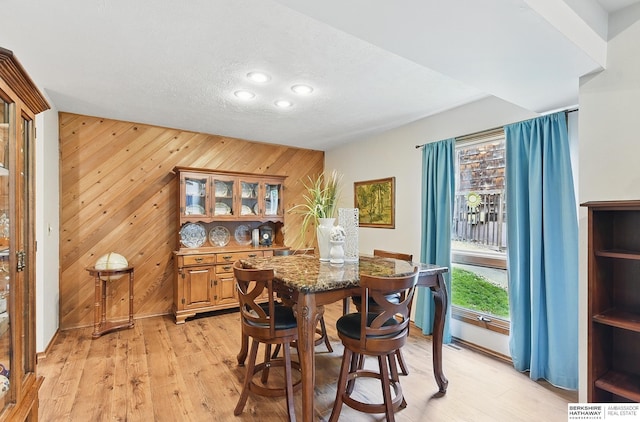 301 Oakridge Ct, Bellevue, NE 68005 - dining space featuring wooden walls, light wood finished floors, recessed lighting, a textured ceiling, and baseboards