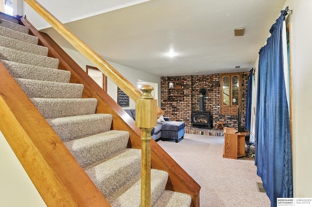 301 Oakridge Ct, Bellevue, NE 68005 - staircase featuring a wood stove and carpet