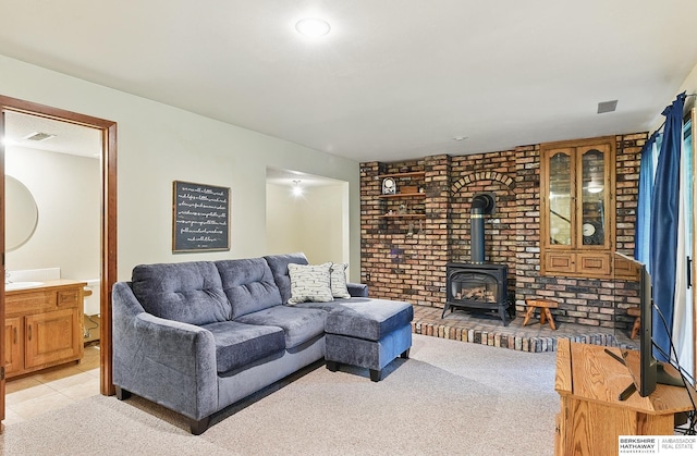 301 Oakridge Ct, Bellevue, NE 68005 - living room with a wood stove and light carpet