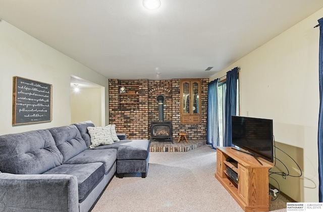 301 Oakridge Ct, Bellevue, NE 68005 - carpeted living room with a wood stove and brick wall