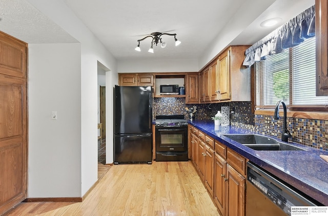 301 Oakridge Ct, Bellevue, NE 68005 - kitchen with black appliances, a sink, light wood-style flooring, backsplash, and brown cabinets