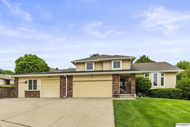 13952 Frederick Cir, Omaha, NE 68138 - view of front of property with concrete driveway, a front lawn, brick siding, an attached garage, and roof with shingles