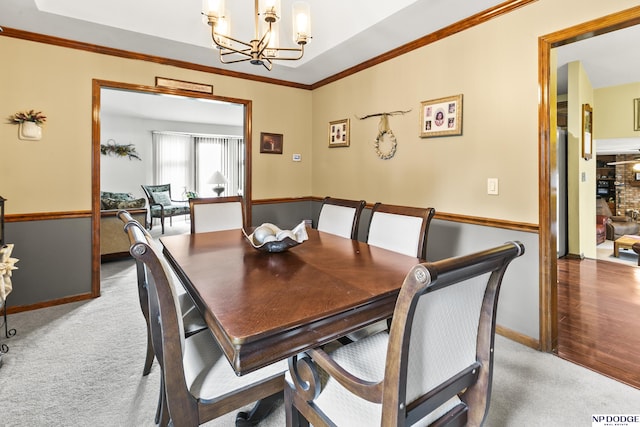 13952 Frederick Cir, Omaha, NE 68138 - carpeted dining space featuring a chandelier, crown molding, and baseboards