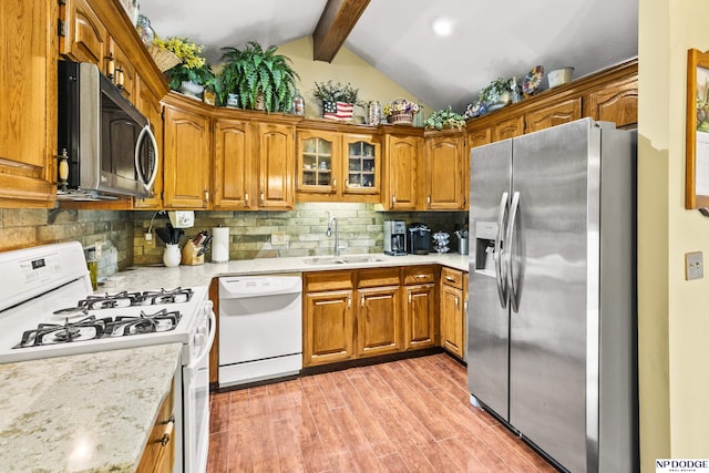 13952 Frederick Cir, Omaha, NE 68138 - kitchen featuring stainless steel appliances, a sink, and brown cabinets