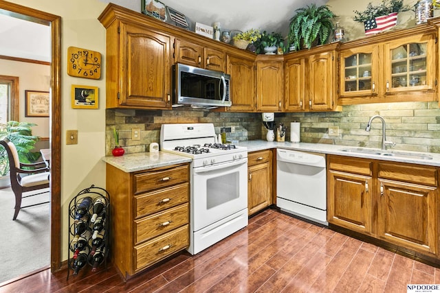 13952 Frederick Cir, Omaha, NE 68138 - kitchen with white appliances, a sink, dark wood-style flooring, backsplash, and brown cabinets