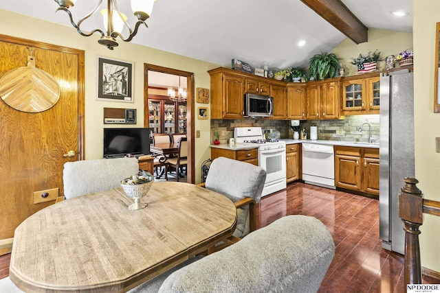 13952 Frederick Cir, Omaha, NE 68138 - kitchen with appliances with stainless steel finishes, a chandelier, dark wood-style flooring, brown cabinets, and backsplash