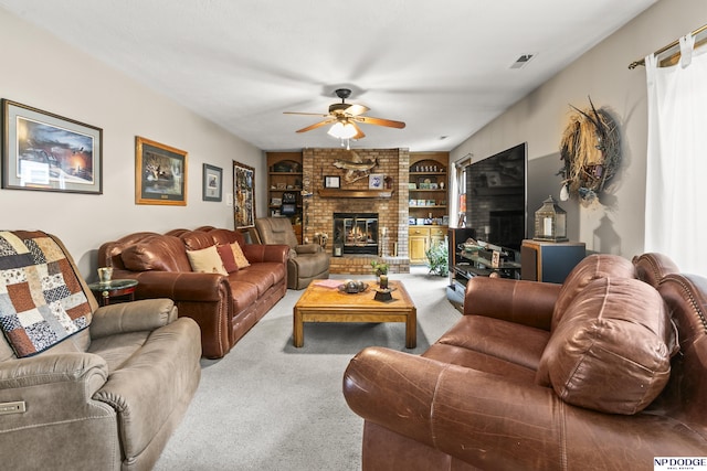 13952 Frederick Cir, Omaha, NE 68138 - living room featuring carpet floors, a ceiling fan, built in features, and a brick fireplace