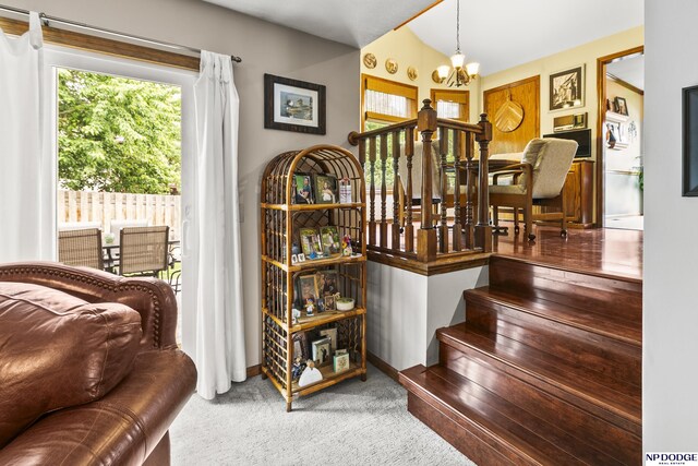 13952 Frederick Cir, Omaha, NE 68138 - staircase featuring a chandelier and carpet