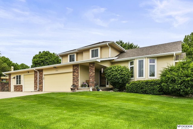 13952 Frederick Cir, Omaha, NE 68138 - view of front of house featuring a front lawn, driveway, a garage, and brick siding