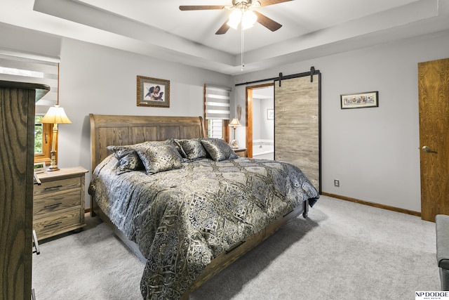 13952 Frederick Cir, Omaha, NE 68138 - carpeted bedroom featuring a barn door, multiple windows, a raised ceiling, and baseboards