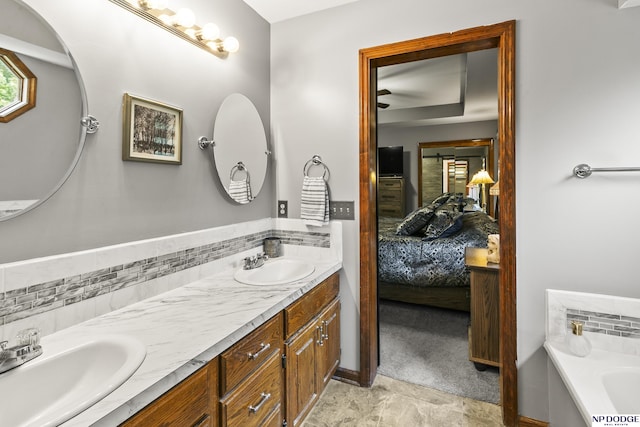 13952 Frederick Cir, Omaha, NE 68138 - ensuite bathroom with double vanity, a tub, and decorative backsplash