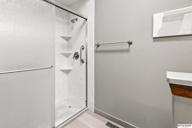 13952 Frederick Cir, Omaha, NE 68138 - bathroom with a stall shower and wood finished floors